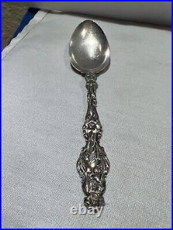 Sterling silver ornate spoon with beautiful flowers the full length of handle