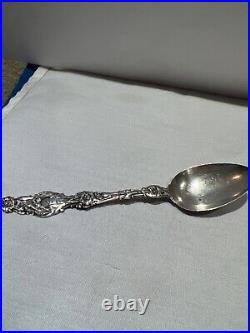 Sterling silver ornate spoon with beautiful flowers the full length of handle